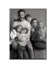 a family poses for a black and white photo