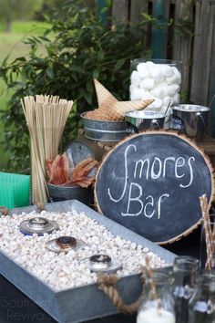 there is a sign that says smores bar next to other foods and drinks on the table