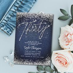 a blue and white wedding card with the word happily written on it next to flowers