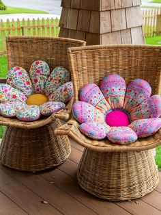 two wicker chairs with flower cushions on them