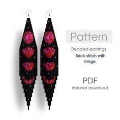 a pair of black and red earrings with hearts on them