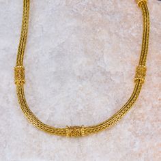 This foxtail chain necklace features detailed scrolling barrel shaped stations. It is intricately crafted in 18k yellow gold and shows a beautiful patina. It hangs 18 inches in length and is finished with a hidden box clasp with a safety. Formal Byzantine Necklace With Intricate Design, Gold Byzantine Necklace With Intricate Design, Byzantine Yellow Gold Necklaces With Intricate Design, Yellow Gold Byzantine Necklace With Wheat Chain, Yellow Gold Byzantine Wheat Chain Necklace, Byzantine Style Yellow Gold Necklace With Wheat Chain, Byzantine Style Yellow Gold Wheat Chain Necklace, Box Clasp, Station Necklace