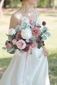 a woman in a white dress holding a bouquet