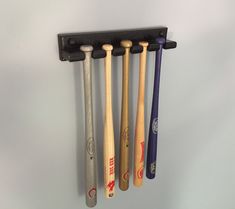 four baseball bats hanging on the wall