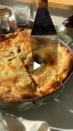 a pie is being cut with a knife