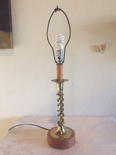 a table with a lamp on top of it and a cord attached to the base