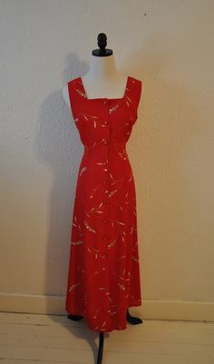 Long Red 1990's Sleeveless Maxi Dress with white floral pattern. Criss-Cross back straps at back neckline. Attached Self-Tie at waist. Front Button closure.    Matching Over Blouse/Jacket with light padding in shoulders. Era: 1990's. Fabric: Polyester. Size: S/M, Bust 36in, Waist 34in, Hips 38in, Length 51in. Lay Flat Measurements. Classic Red Summer Dress, Red Maxi Dress, Red Maxi, Red Dress Maxi, Long Red, Sleeveless Maxi Dress, Dress Clothes For Women, Criss Cross, Favorite Outfit