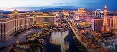 an aerial view of the las vegas strip at night with ferris wheel in foreground