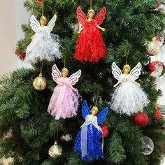 the christmas tree is decorated with angel ornaments