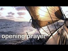 a sailboat with the words opening prayer written on it's side in front of an ocean