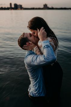 a man and woman kissing in the water