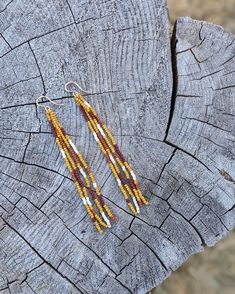 Our beloved long fringe beaded earring style, but in a trending mustard patchwork design. Featuring beautiful matte mustard, rust, oxblood & ivory beads. Beautifully dramatic, comfortably lightweight. Enjoy the playful, free flowing style of beaded fringe earrings, without the weight. Featuring 4 strands of hand woven matte glass beads. These unique matte glass beads have a very luxe look and feel to them. Colors: These beaded earrings feature a patchwork design of matte mustard yellow, ivory, o Yellow Beaded Fringe Earrings With Round Beads, Gold Bohemian Earrings With Beaded Fringe, Yellow Beaded Fringe Earrings, Yellow Beaded Fringe Drop Earrings, Artisan Brown Beaded Fringe Earrings, Beaded Fringe Earrings, Beaded Earring, Long Fringe, Long Fringes