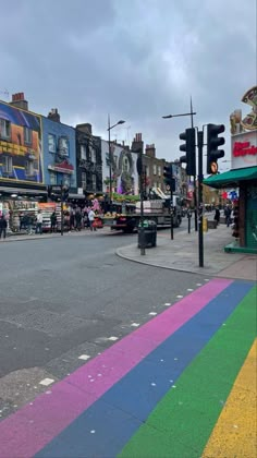 a rainbow painted street in the middle of town