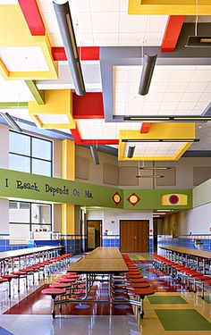 an empty school cafeteria with tables and chairs