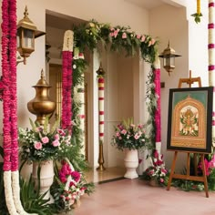 a luxurious and elaborate floral arrangement, possibly part of a wedding or a ceremonial event. The setup includes hanging floral chandeliers, large flower sculptures resembling lotus flowers, and intricately designed floral arches. The backdrop includes lush greenery, and the setting appears to be outdoors or in a large open space with a high ceiling. The overall ambiance is elegant and opulent, with a strong emphasis on floral decor. Lotus Wedding Decor Indian, Indian Home Engagement Decor, Banquet Decorations Elegant, Lotus Decoration Ideas Wedding, Lotus Theme Decoration, Indian Wedding Backdrop Decorations, Traditional Hindu Wedding Decor, Indian Wedding Decorations Mandap, Lotus Decoration Ideas