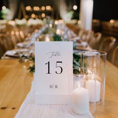 a table with candles and a sign that says file 15 hr on it, surrounded by chairs