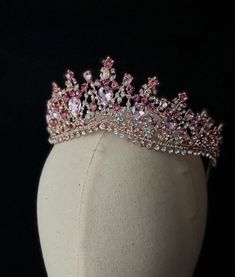 a pink tiara on top of a white mannequin