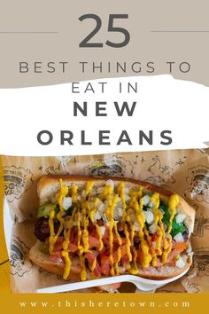 a hot dog covered in mustard and ketchup on top of a bun with the words 25 best things to eat in new orleans