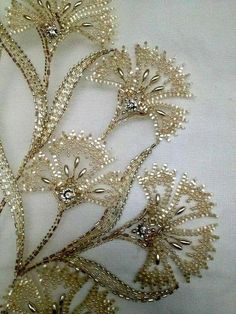 some very pretty gold brooches on a white cloth