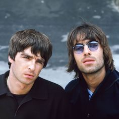 two men standing next to each other wearing sunglasses