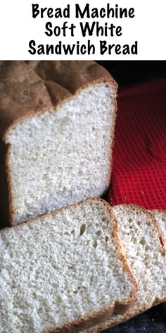 two slices of bread sitting on top of a red towel next to a loaf of bread