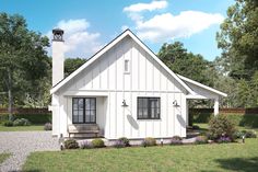 a small white house sitting on top of a lush green field