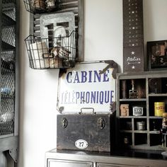 an old trunk sitting on top of a dresser next to a basket filled with bottles