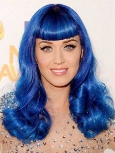 a woman with bright blue hair and bangs