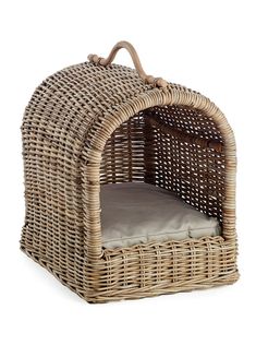 a wicker dog bed with a cushion