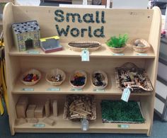 a shelf with small world toys and other items on it's shelves for sale