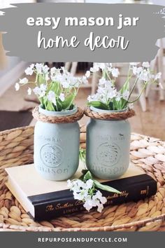 two mason jars sitting on top of a table with flowers in them and the words easy mason jar home decor