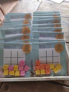 several pieces of candy sitting on top of a wooden table next to each other in plastic bags