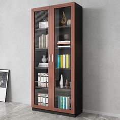 a tall bookcase with many books in it next to a painting on the wall