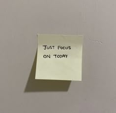 a piece of paper with the words just focus on today written on it, pinned to a wall