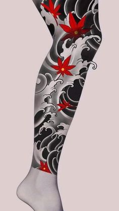 a woman's leg with red flowers and black swirls on the bottom half