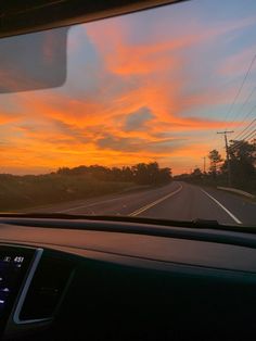 the sun is setting on an empty highway