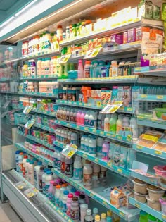 an aisle in a store filled with lots of different types of food and drink bottles