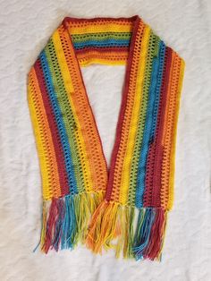 a multicolored crocheted scarf with fringes