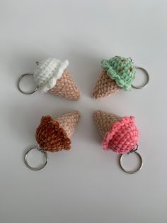 four ice cream cones with crochet on them are shown in three different colors