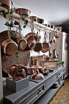 pots and pans are hanging on the wall