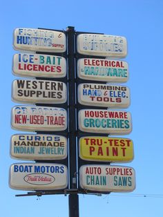 there are many different signs on the pole