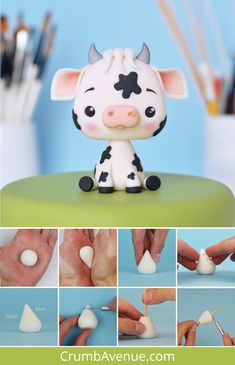 there is a small toy cow sitting on top of a table with it's nails sticking out