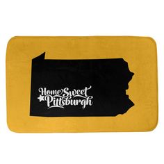 a black and yellow bath mat with the word home sweet pittsburgh on it