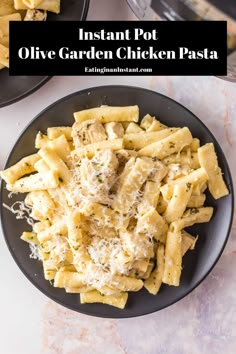 two black plates filled with pasta and chicken