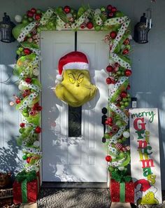 the grinch door decoration is decorated with christmas decorations and presents, including an ornament