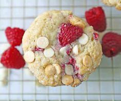 raspberry white chocolate chip cookies on a cooling rack with raspberries and almonds