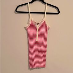 So Cute Thrills By Nordstrom 100% Cotton Strawberry Pink And Creamy White Striped Camisole. Darling Detail In The Front And Pretty Lace Around The Neckline And Arm Area. Wear This Under A Gorgeous Cashmere Sweater, Blazer Or Dress It Down With A Jean Jacket. Or Wear As A Tank To Bed. Very Stretchy And Comfortable. Size Medium. This Is Small Looking But Has Tons Of Stretch Fitted Striped Tank Top With Spaghetti Straps, Striped Fitted Tops With Tank Straps, Fitted Striped Tops With Tank Straps, Striped Fitted Tank Top With Tank Straps, Cute Fitted Sleeveless Camisole, Cute Fitted Tank Camisole, Fitted Sleeveless Cute Camisole, Cute Camisole With Lace Trim, Cute Stretch Cami Tank Top