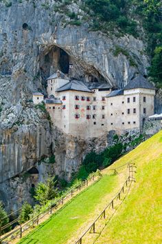 an old castle built into the side of a mountain