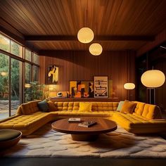 a living room filled with yellow couches and round tables in front of large windows