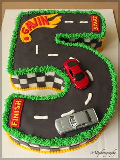 a cake shaped like the number five with cars on it